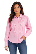 Woman wearing a pink shirt with decorative elements on a white background