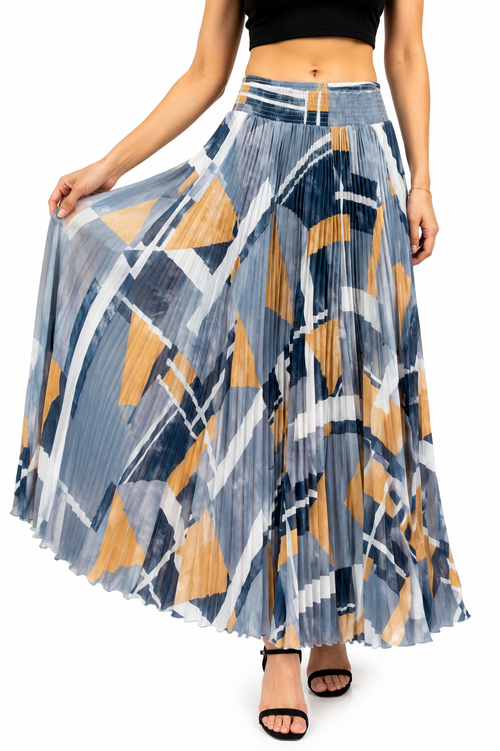 Model wearing an abstract geometric pleated maxi skirt in slate blue, amber and white