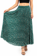Model wearing a deep green bandhani print pleated maxi skirt with white dot patterns and elasticated waistband