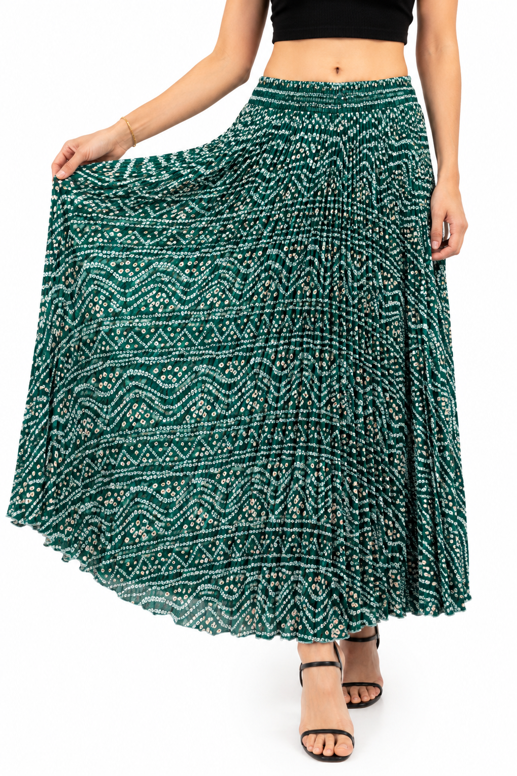 Model wearing a deep green bandhani print pleated maxi skirt with white dot patterns and elasticated waistband